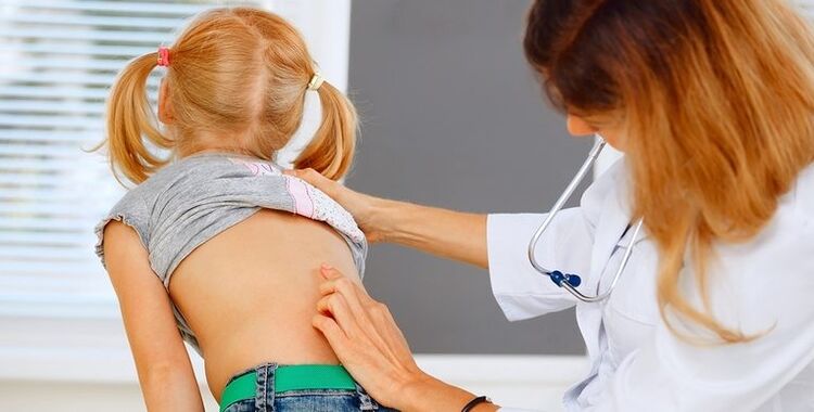 the doctor checks the child's back for back pain